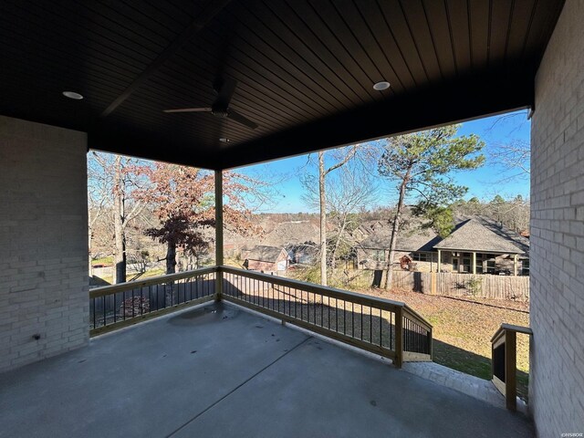 view of patio / terrace with ceiling fan and fence