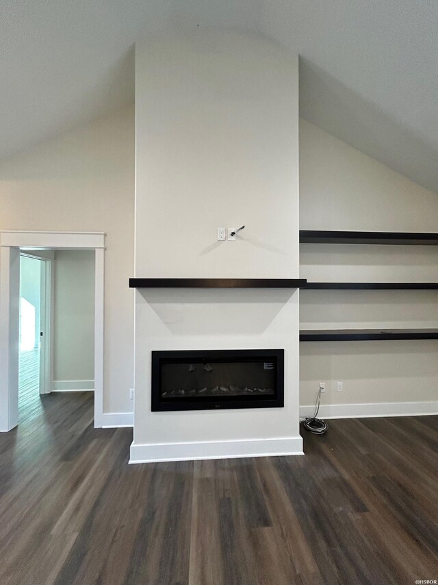 interior details with a glass covered fireplace, baseboards, and wood finished floors