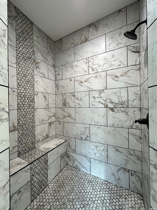 full bath with tiled shower