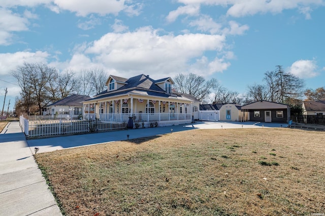 view of front of house with a porch, a fenced front yard, and a front yard