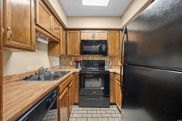 203 Stearns Pt Unit E1, Hot Springs, AR 71913 - kitchen featuring black appliances, a sink, light tile patterned floors, backsplash, and brown cabinets
