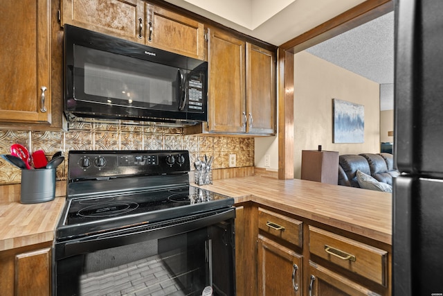 203 Stearns Pt Unit E1, Hot Springs, AR 71913 - kitchen with butcher block counters, black appliances, tasteful backsplash, brown cabinets, and open floor plan