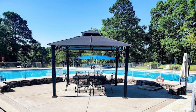 pool with a gazebo and fence