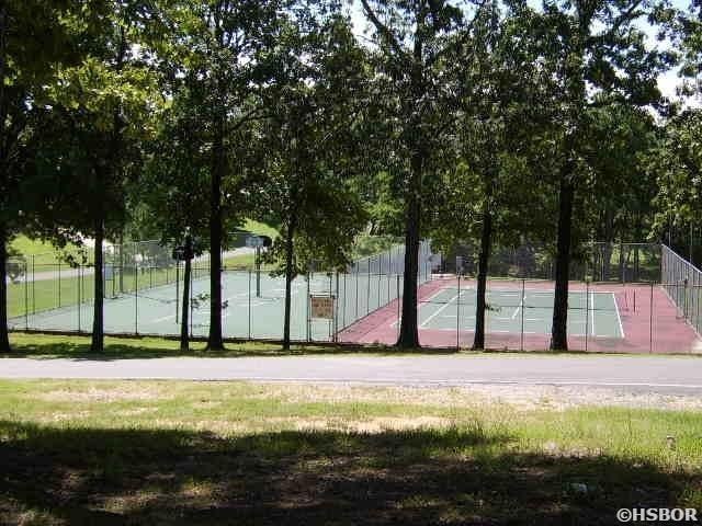 view of home's community featuring fence and community basketball court