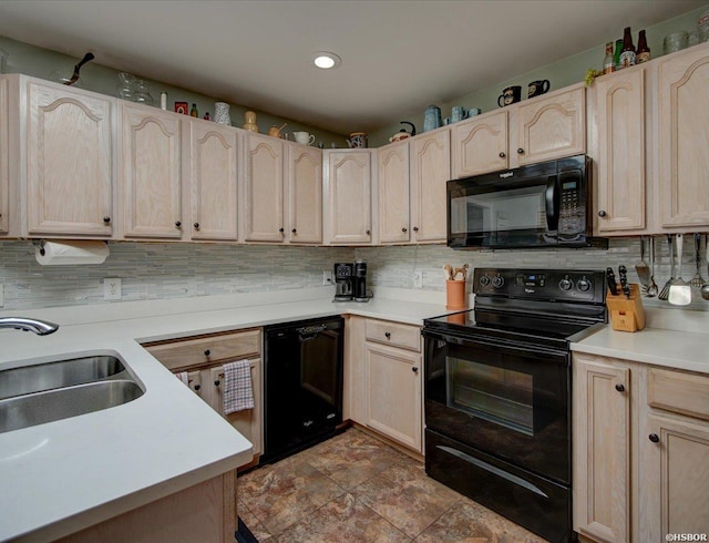 kitchen featuring black appliances, light brown cabinets, and tasteful backsplash