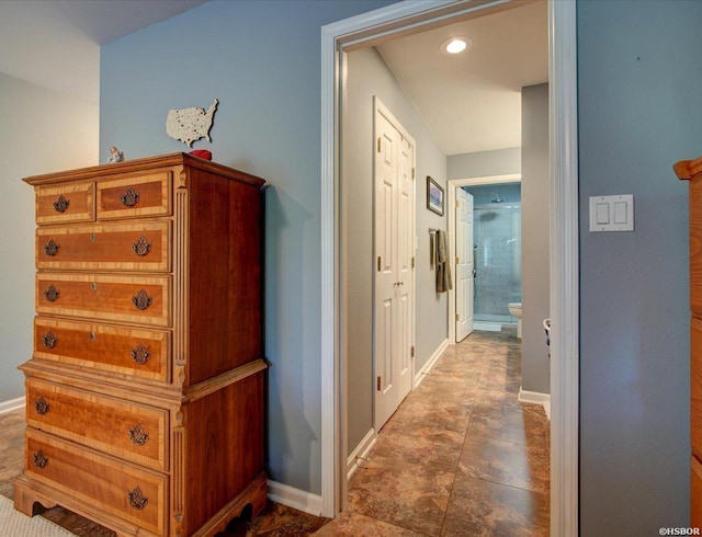 hallway with recessed lighting and baseboards