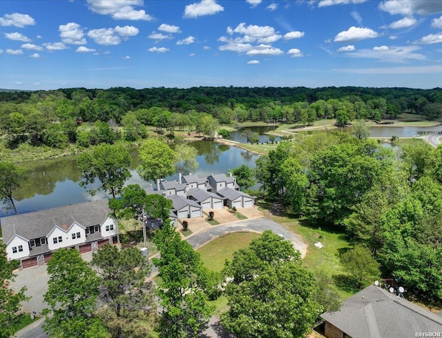 drone / aerial view featuring a view of trees and a water view