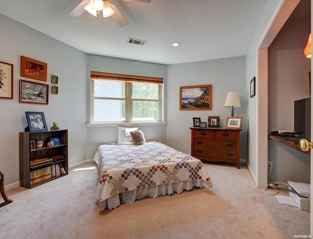 carpeted bedroom with visible vents, baseboards, and ceiling fan