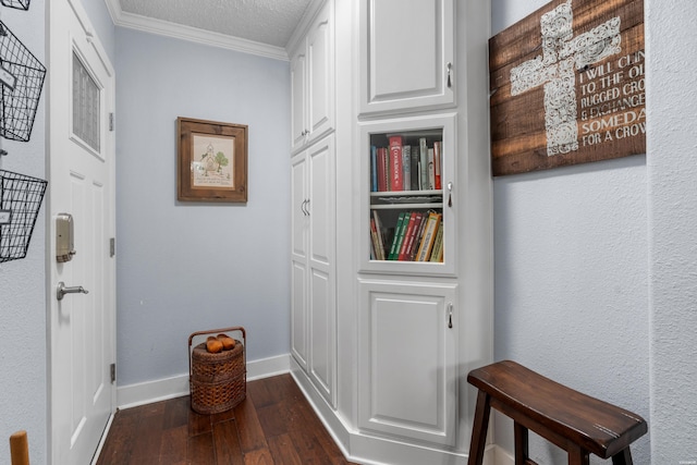 corridor featuring a textured ceiling, a textured wall, dark wood-style flooring, baseboards, and ornamental molding