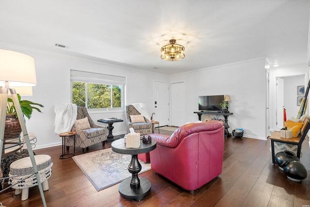 living area featuring ornamental molding, visible vents, dark wood finished floors, and baseboards