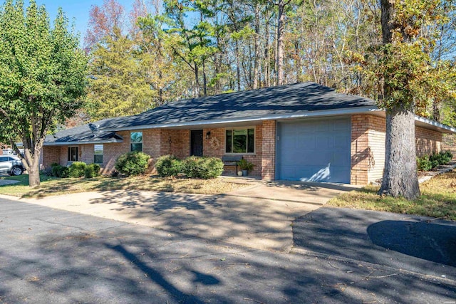 view of front of property with a garage, brick siding, and driveway