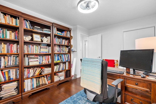 office area with a textured ceiling and dark wood-style flooring