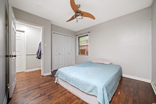 bedroom featuring baseboards, wood finished floors, a closet, and ceiling fan