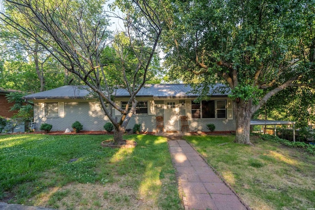 single story home featuring brick siding and a front lawn