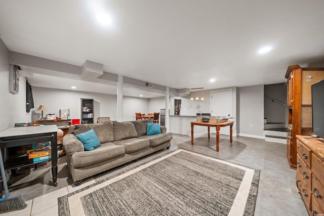 living area featuring recessed lighting, finished concrete floors, and stairs