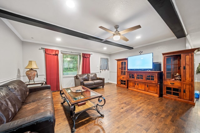 living area featuring beam ceiling, wood finished floors, ceiling fan, crown molding, and recessed lighting