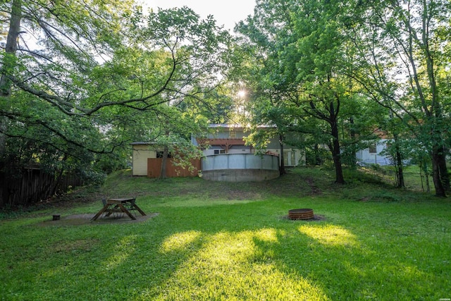 view of yard with a fire pit