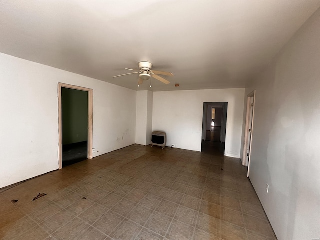 unfurnished living room featuring heating unit and ceiling fan