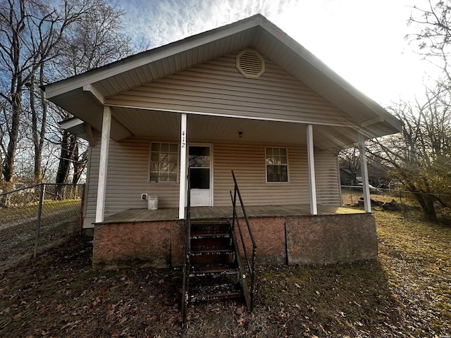 view of front of house with a porch and fence