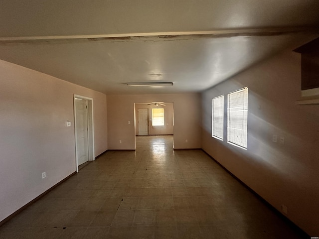 unfurnished room featuring baseboards and tile patterned floors