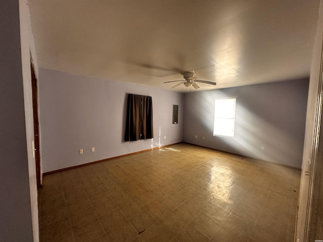 empty room featuring light floors, ceiling fan, and baseboards