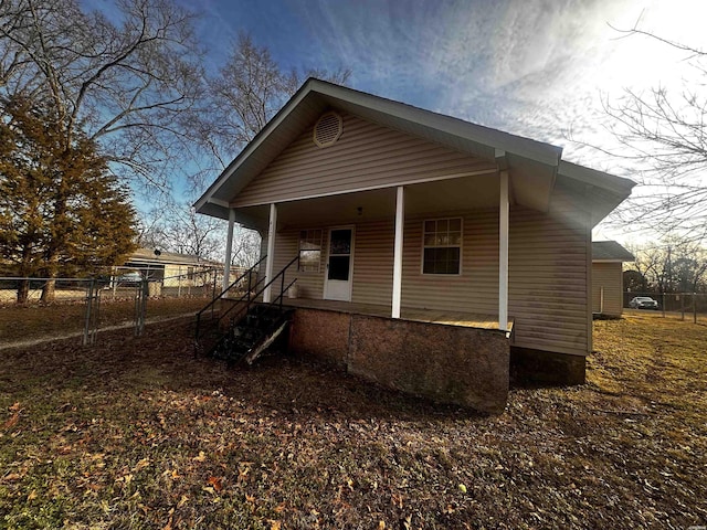 bungalow with covered porch and fence