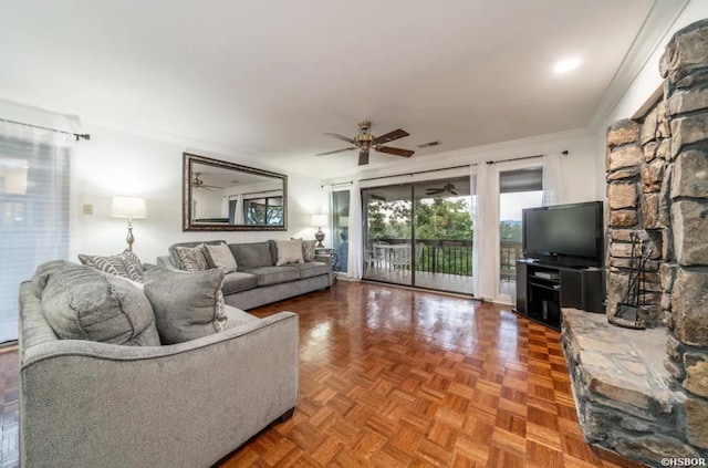 living room featuring ornamental molding and a ceiling fan