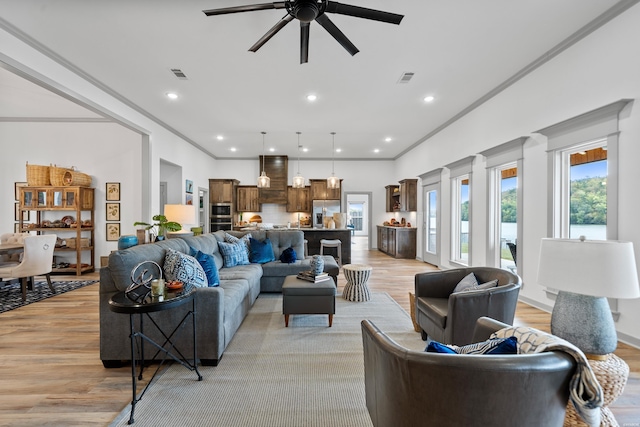 living area featuring visible vents, recessed lighting, ornamental molding, ceiling fan, and light wood-style floors