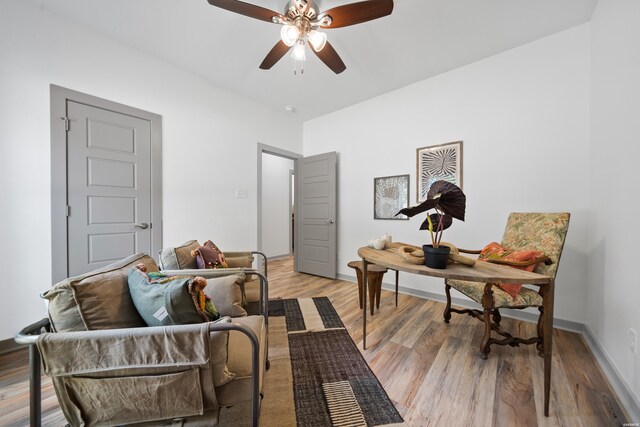 home office featuring light wood-style flooring, baseboards, and ceiling fan