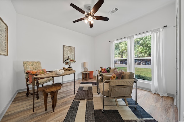 sitting room featuring visible vents, a healthy amount of sunlight, light wood-style floors, and ceiling fan