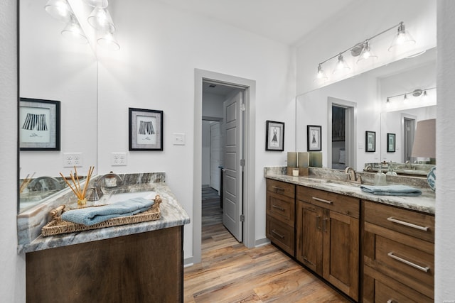 bathroom with vanity and wood finished floors