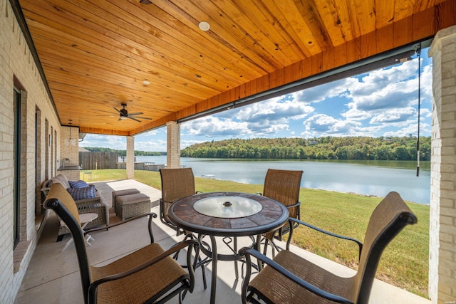 view of patio / terrace with outdoor dining area and a water view