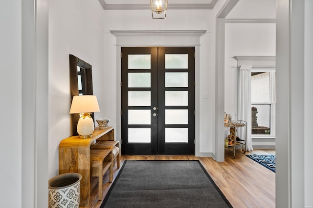 foyer with a wealth of natural light, french doors, and wood finished floors