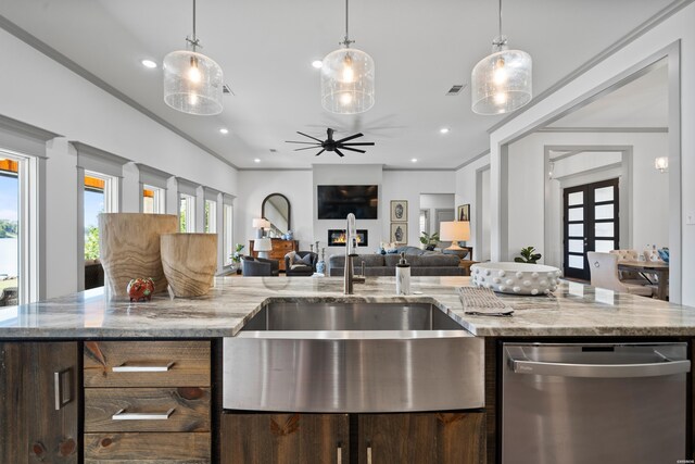 kitchen with visible vents, ceiling fan, open floor plan, stainless steel dishwasher, and a sink