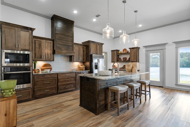 kitchen with visible vents, crown molding, decorative backsplash, appliances with stainless steel finishes, and open shelves