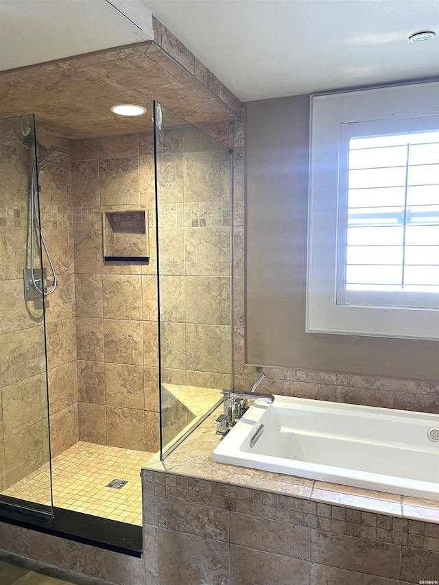 full bathroom featuring a stall shower and a bath