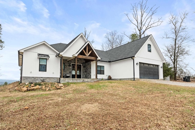 modern farmhouse with driveway, a front lawn, and a shingled roof