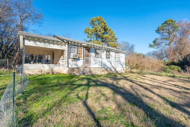 back of property with cooling unit and a yard