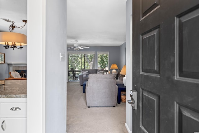 250 Grand Isle Dr Unit 5-A, Hot Springs, AR 71913 - living room with light carpet, ceiling fan with notable chandelier, a fireplace, and visible vents