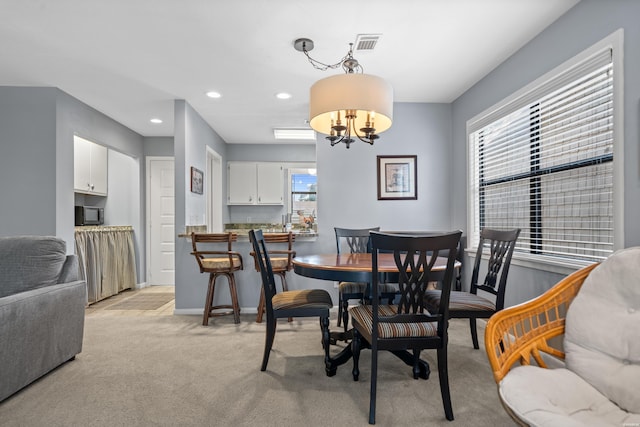 250 Grand Isle Dr Unit 5-A, Hot Springs, AR 71913 - dining space featuring light colored carpet, a healthy amount of sunlight, a chandelier, and visible vents