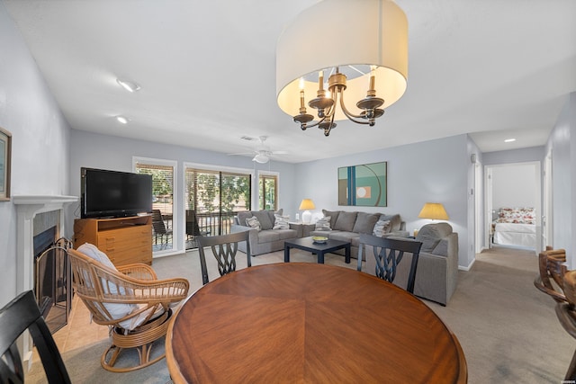 250 Grand Isle Dr Unit 5-A, Hot Springs, AR 71913 - dining area with a tiled fireplace, carpet flooring, and ceiling fan with notable chandelier