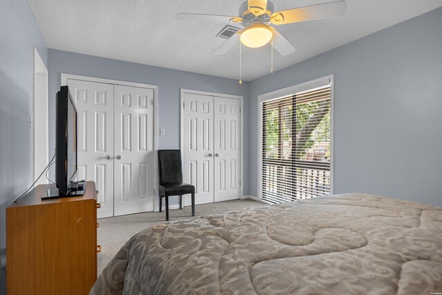 250 Grand Isle Dr Unit 5-A, Hot Springs, AR 71913 - carpeted bedroom featuring multiple closets, visible vents, ceiling fan, and a textured ceiling