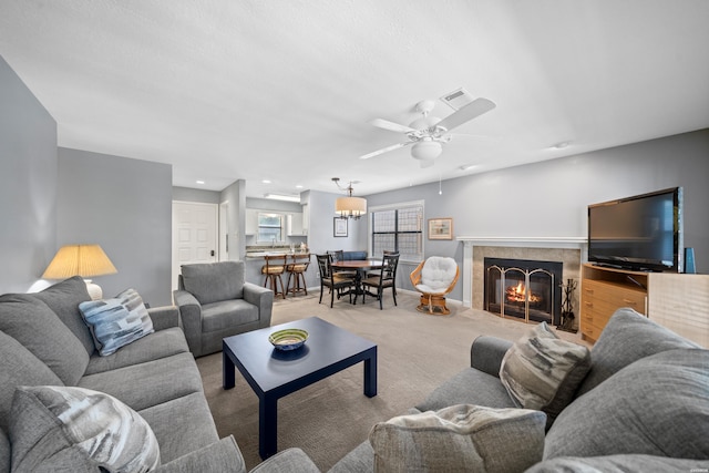 250 Grand Isle Dr Unit 5-A, Hot Springs, AR 71913 - living room featuring visible vents, baseboards, a tiled fireplace, a ceiling fan, and light colored carpet