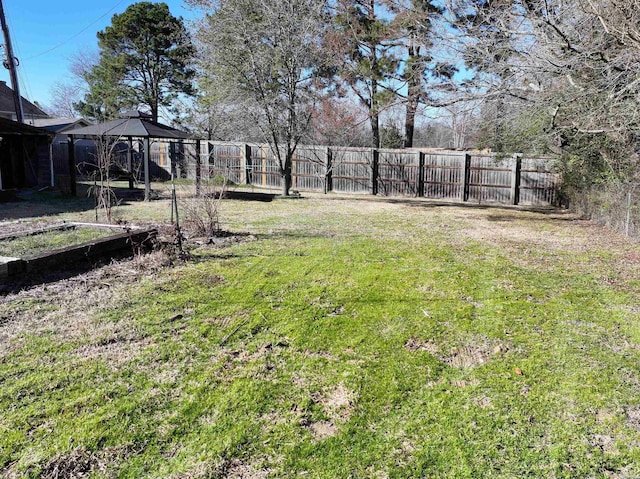 view of yard with fence private yard and a gazebo