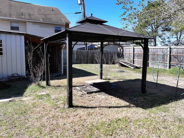 view of yard featuring a carport, fence, and a gazebo