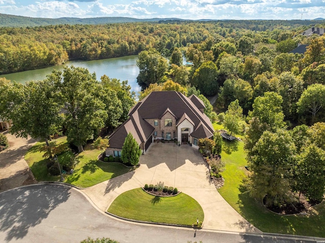 birds eye view of property with a forest view and a water view