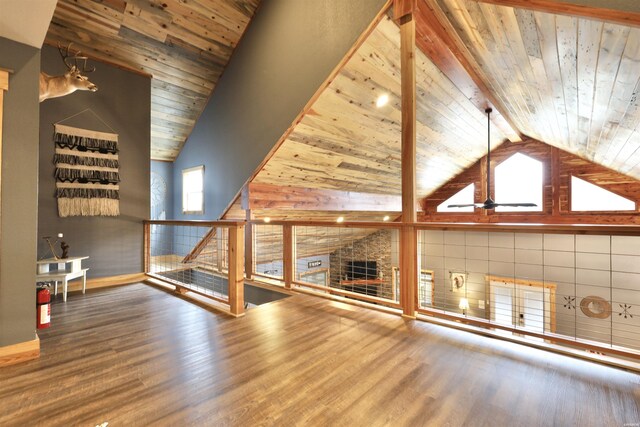 unfurnished living room with high vaulted ceiling, wooden ceiling, wood finished floors, and beam ceiling