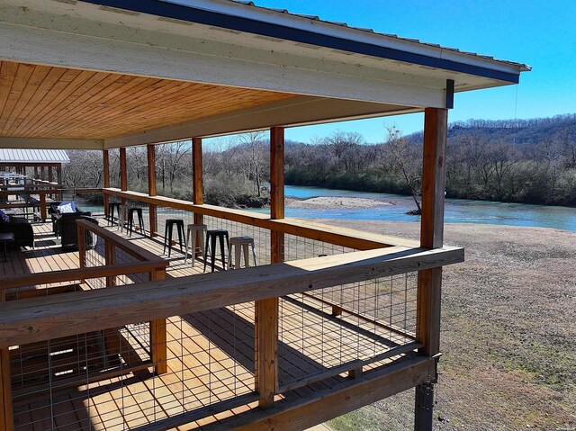 dock area featuring a forest view and a water view