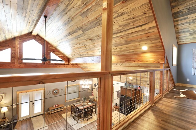 additional living space featuring lofted ceiling with beams, wooden ceiling, baseboards, and wood finished floors