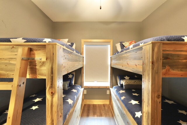 bedroom featuring lofted ceiling and wood finished floors